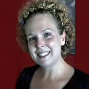 Smiling woman with short blonde curly hair